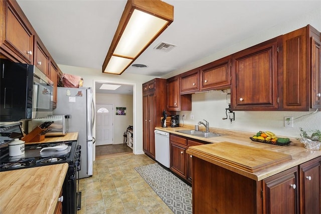 4234 Center Ave, Norco, CA 92860 - kitchen featuring black range with gas stovetop, white dishwasher, wood counters, and stainless steel microwave