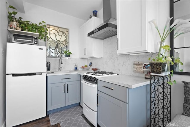 360 W Ocean Blvd Unit 1103, Long Beach, CA 90802 - kitchen featuring white appliances, wall chimney exhaust hood, light countertops, decorative backsplash, and white cabinetry