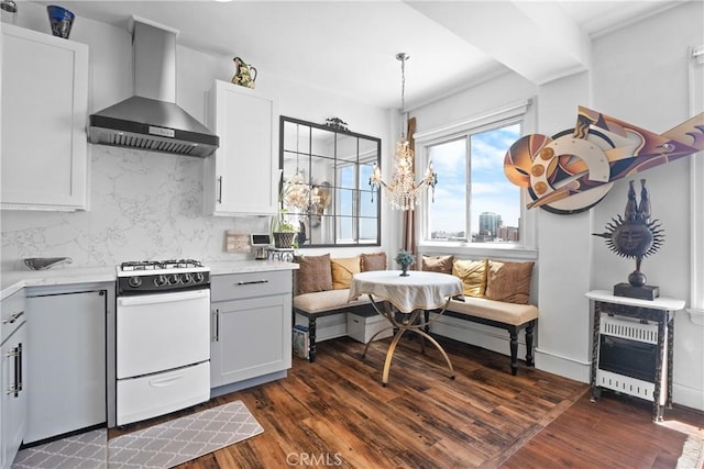 360 W Ocean Blvd Unit 1103, Long Beach, CA 90802 - kitchen with wall chimney exhaust hood, gas range gas stove, dark wood finished floors, light countertops, and decorative light fixtures
