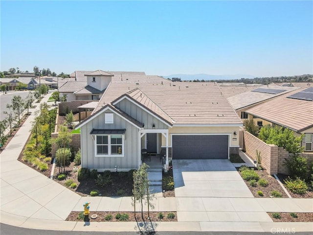 32096 Hyacinth Way, Temecula, CA 92591 - view of front facade featuring board and batten siding, driveway, a tiled roof, a residential view, and an attached garage