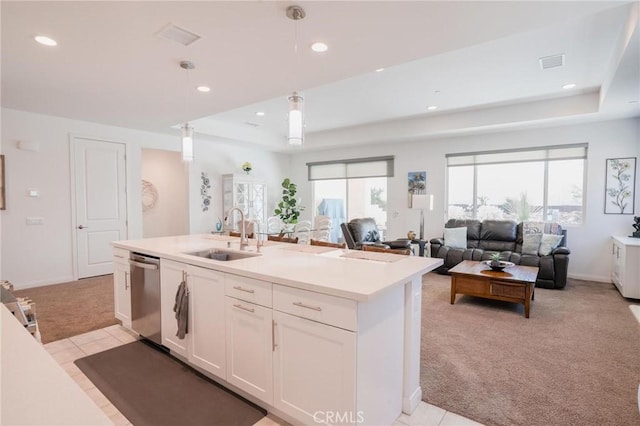 32096 Hyacinth Way, Temecula, CA 92591 - kitchen with stainless steel dishwasher, light colored carpet, a raised ceiling, white cabinets, and light countertops