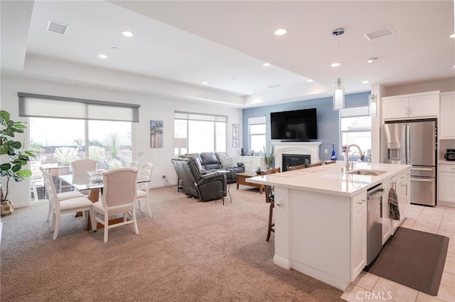 32096 Hyacinth Way, Temecula, CA 92591 - kitchen featuring appliances with stainless steel finishes, a raised ceiling, white cabinetry, recessed lighting, and light countertops