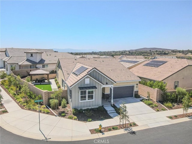 32096 Hyacinth Way, Temecula, CA 92591 - view of front facade featuring board and batten siding, driveway, a garage, a tiled roof, and a residential view