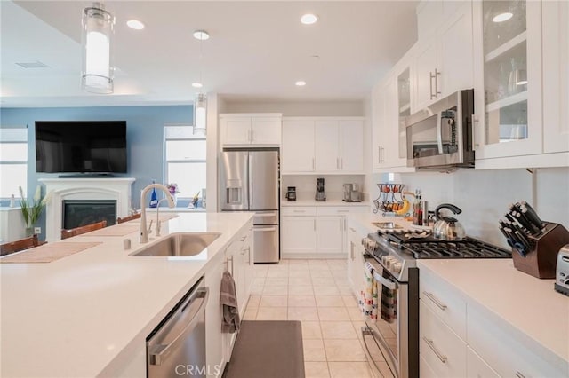 32096 Hyacinth Way, Temecula, CA 92591 - kitchen featuring appliances with stainless steel finishes, light tile patterned floors, pendant lighting, light countertops, and recessed lighting