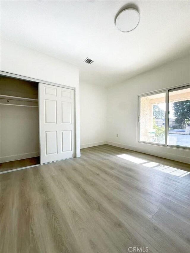 528 S Avington Ave, West Covina, CA 91790 - unfurnished bedroom featuring wood finished floors and a closet