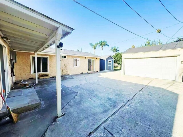 528 S Avington Ave, West Covina, CA 91790 - view of patio with an outdoor structure and a garage