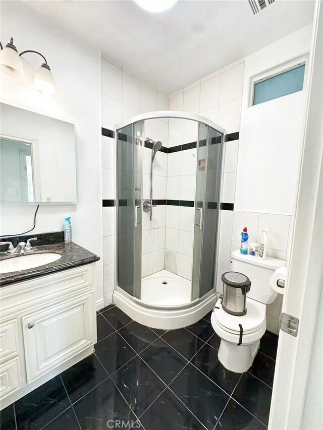 528 S Avington Ave, West Covina, CA 91790 - full bath with vanity, tile patterned floors, a shower stall, and tile walls