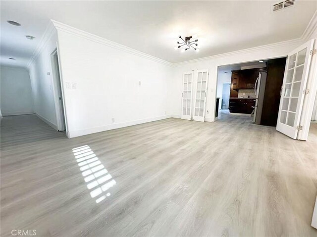 528 S Avington Ave, West Covina, CA 91790 - unfurnished living room with french doors, ornamental molding, and light wood-style floors