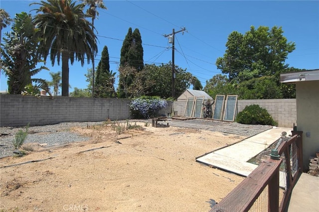 267 E 16th St, Costa Mesa, CA 92627 - fenced backyard featuring a greenhouse and an outdoor structure