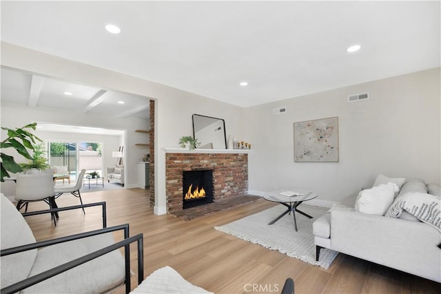 1347 W Princeton St, Ontario, CA 91762 - living room featuring light wood-style floors, recessed lighting, beam ceiling, and a brick fireplace