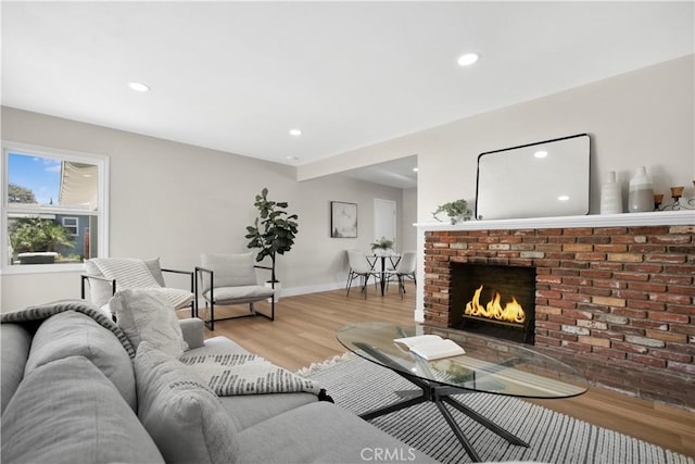 1347 W Princeton St, Ontario, CA 91762 - living room featuring recessed lighting, a brick fireplace, and light wood-style flooring