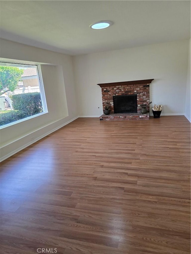 4163 Stotts St, Riverside, CA 92503 - unfurnished living room featuring wood finished floors and a brick fireplace