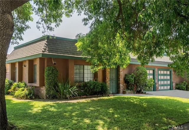 304 S Minnesota Ave, Glendora, CA 91741 - view of front of home featuring driveway, a front yard, stucco siding, and mansard roof