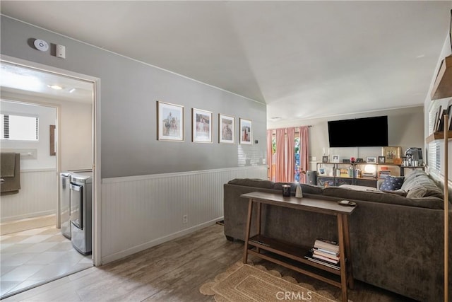 304 S Minnesota Ave, Glendora, CA 91741 - living area with washer and clothes dryer, healthy amount of natural light, wainscoting, and wood finished floors