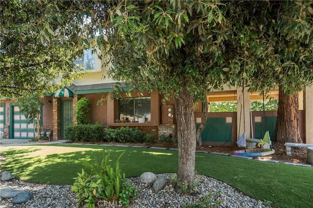 304 S Minnesota Ave, Glendora, CA 91741 - obstructed view of property featuring a front lawn, stucco siding, and brick siding