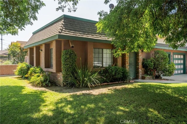 304 S Minnesota Ave, Glendora, CA 91741 - view of side of property with a yard, stucco siding, and a garage