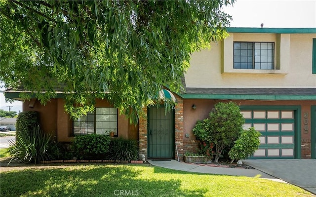 304 S Minnesota Ave, Glendora, CA 91741 - view of front of property featuring stucco siding, a garage, a front lawn, brick siding, and driveway