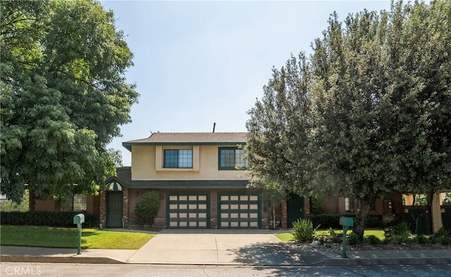 304 S Minnesota Ave, Glendora, CA 91741 - view of front facade with stucco siding, an attached garage, and driveway