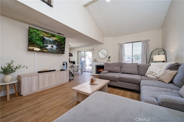 818 Live Oak Pl, Corona, CA 92882 - living area with light wood-style flooring, high vaulted ceiling, and a brick fireplace