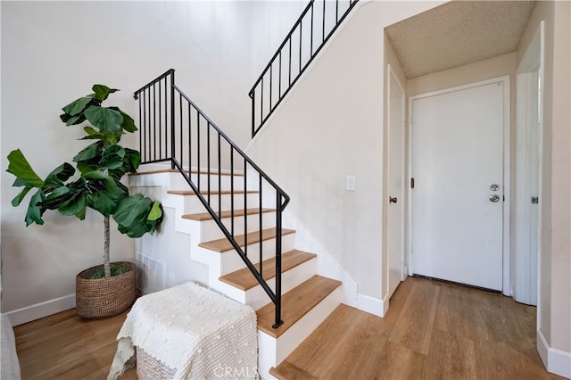 818 Live Oak Pl, Corona, CA 92882 - staircase with wood finished floors and baseboards
