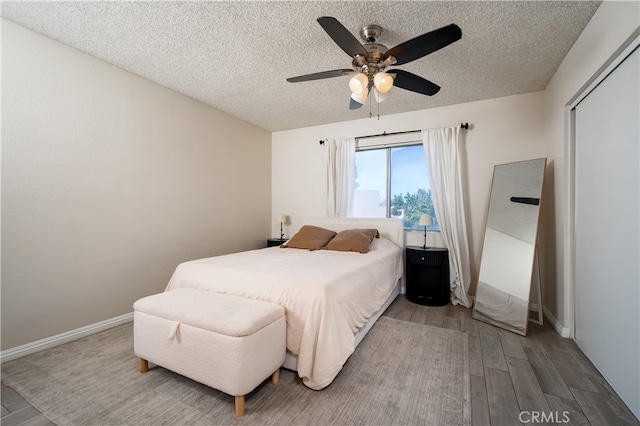 818 Live Oak Pl, Corona, CA 92882 - bedroom featuring wood finished floors, a textured ceiling, and ceiling fan