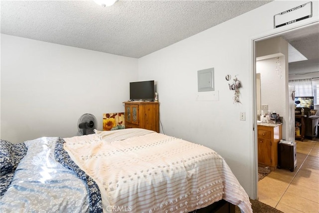 351 W 19th St, Merced, CA 95340 - bedroom with light tile patterned floors and a textured ceiling