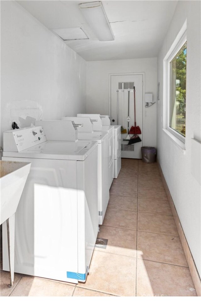 351 W 19th St, Merced, CA 95340 - community laundry room with washing machine and clothes dryer and light tile patterned floors