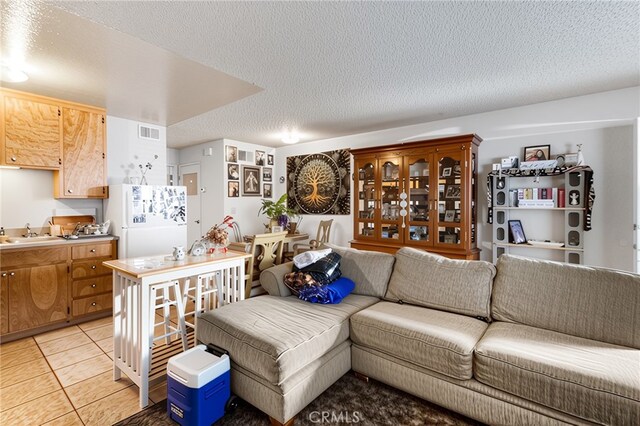 351 W 19th St, Merced, CA 95340 - living area with a textured ceiling and light tile patterned flooring