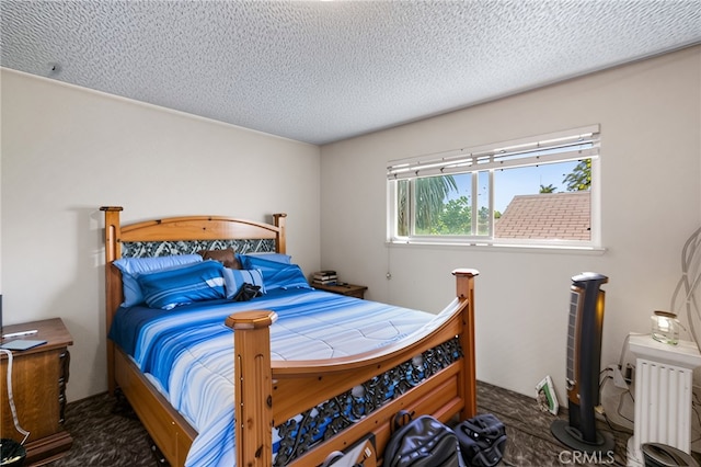 351 W 19th St, Merced, CA 95340 - carpeted bedroom featuring a textured ceiling and radiator heating unit