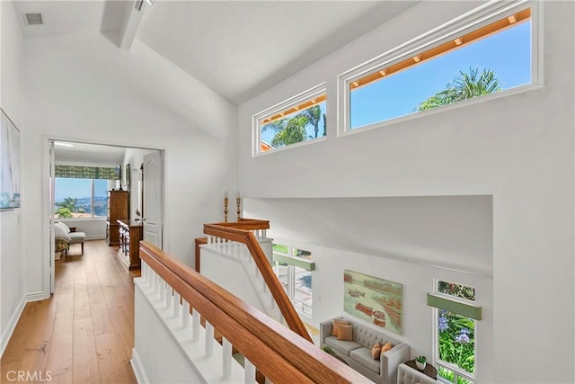 23256 Arelo Ct, Laguna Niguel, CA 92677 - hallway featuring beamed ceiling, light wood-type flooring, plenty of natural light, an upstairs landing, and high vaulted ceiling