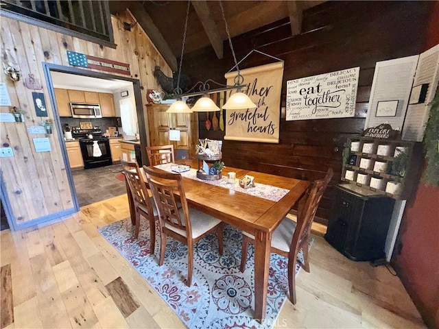 9312 Mountain Meadow Rd, Shingletown, CA 96088 - dining room featuring wooden walls and light wood-style flooring