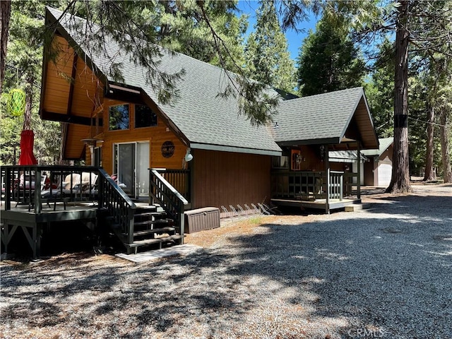 9312 Mountain Meadow Rd, Shingletown, CA 96088 - view of front of property with roof with shingles and a wooden deck