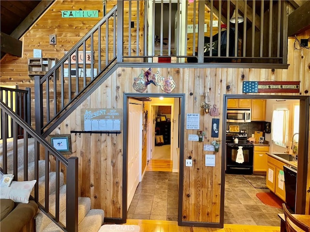 9312 Mountain Meadow Rd, Shingletown, CA 96088 - stairway featuring wood walls and tile patterned flooring