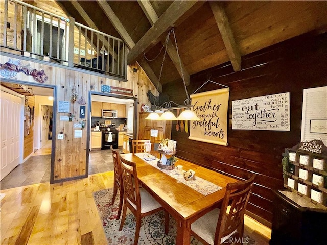 9312 Mountain Meadow Rd, Shingletown, CA 96088 - dining room featuring wood walls, light wood finished floors, high vaulted ceiling, and a wooden ceiling with exposed beams