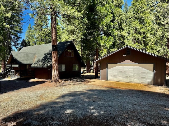 9312 Mountain Meadow Rd, Shingletown, CA 96088 - view of side of home featuring a garage, an outdoor structure, and a shingled roof
