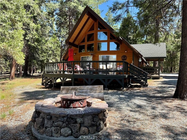9312 Mountain Meadow Rd, Shingletown, CA 96088 - rear view of property with a fire pit and a deck