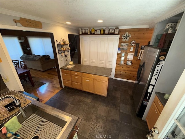 9312 Mountain Meadow Rd, Shingletown, CA 96088 - kitchen featuring wooden walls, crown molding, dark countertops, a textured ceiling, and a peninsula
