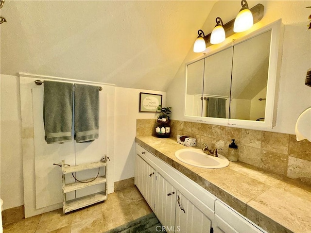 9312 Mountain Meadow Rd, Shingletown, CA 96088 - bathroom with vaulted ceiling, vanity, a shower, and decorative backsplash