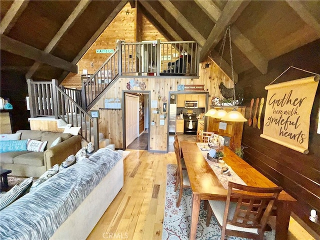 9312 Mountain Meadow Rd, Shingletown, CA 96088 - living area with wood walls, light wood-style floors, and stairway