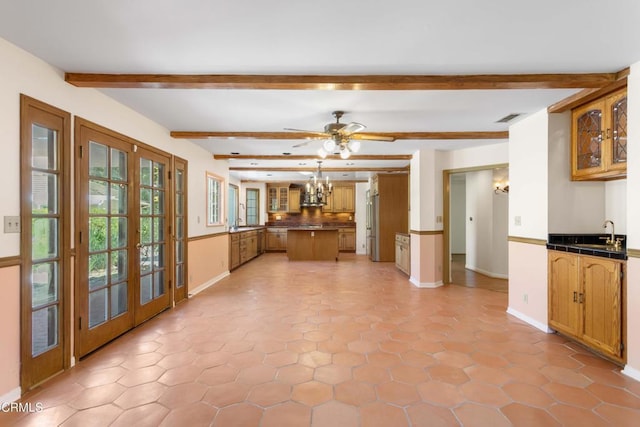 2000 Morongo Dr, Camarillo, CA 93012 - kitchen featuring beam ceiling, french doors, glass insert cabinets, high quality fridge, and brown cabinets