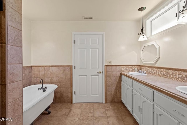 2000 Morongo Dr, Camarillo, CA 93012 - bathroom with tile walls, a soaking tub, double vanity, a wainscoted wall, and tile patterned floors