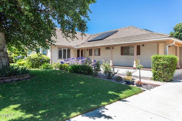 2000 Morongo Dr, Camarillo, CA 93012 - view of front of home with a front lawn, roof mounted solar panels, a tile roof, a garage, and covered porch