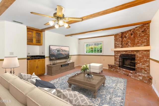 2000 Morongo Dr, Camarillo, CA 93012 - living area featuring tile patterned floors, beam ceiling, a fireplace, and a ceiling fan