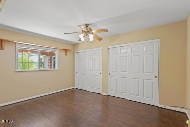 2000 Morongo Dr, Camarillo, CA 93012 - unfurnished bedroom featuring two closets, dark wood finished floors, and ceiling fan
