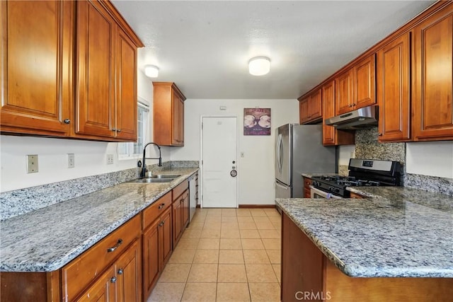 11813 Colima Rd, Whittier, CA 90604 - kitchen with stainless steel appliances, under cabinet range hood, light stone counters, and brown cabinetry