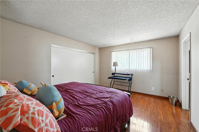11813 Colima Rd, Whittier, CA 90604 - bedroom featuring wood finished floors, a textured ceiling, and a closet