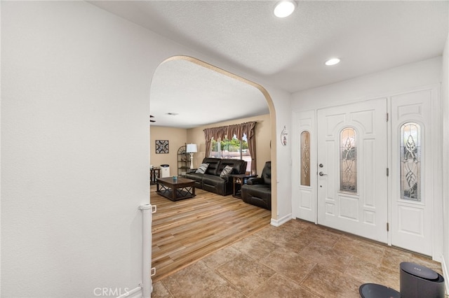 19082 Tecumseh Rd, Apple Valley, CA 92307 - entryway with arched walkways, recessed lighting, and a textured ceiling