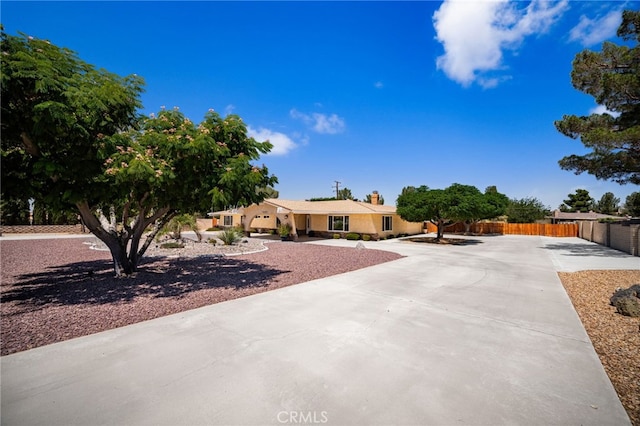19082 Tecumseh Rd, Apple Valley, CA 92307 - view of front of property featuring a chimney, concrete driveway, and stucco siding