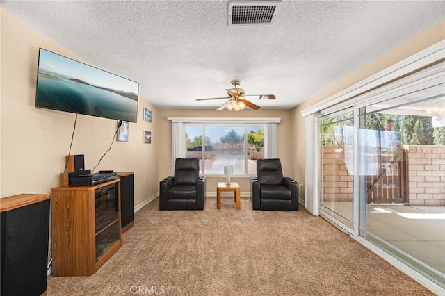 19082 Tecumseh Rd, Apple Valley, CA 92307 - sitting room featuring healthy amount of natural light, carpet floors, a ceiling fan, and a textured ceiling