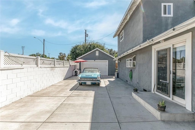 417 N Lamer St, Burbank, CA 91506 - view of patio featuring a garage, concrete driveway, and an outbuilding